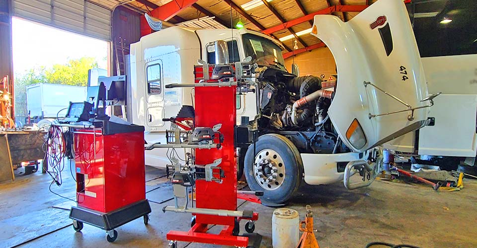 What causes semi-truck suspension damage?