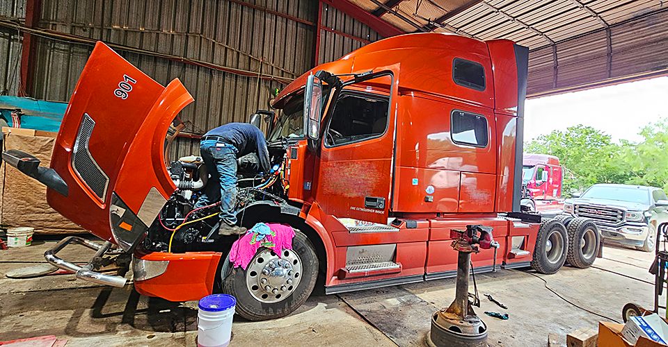 2022 Volvo VNL 860 in the shop at Salazar Semi-Truck Repair Dallas with technician working under the hood